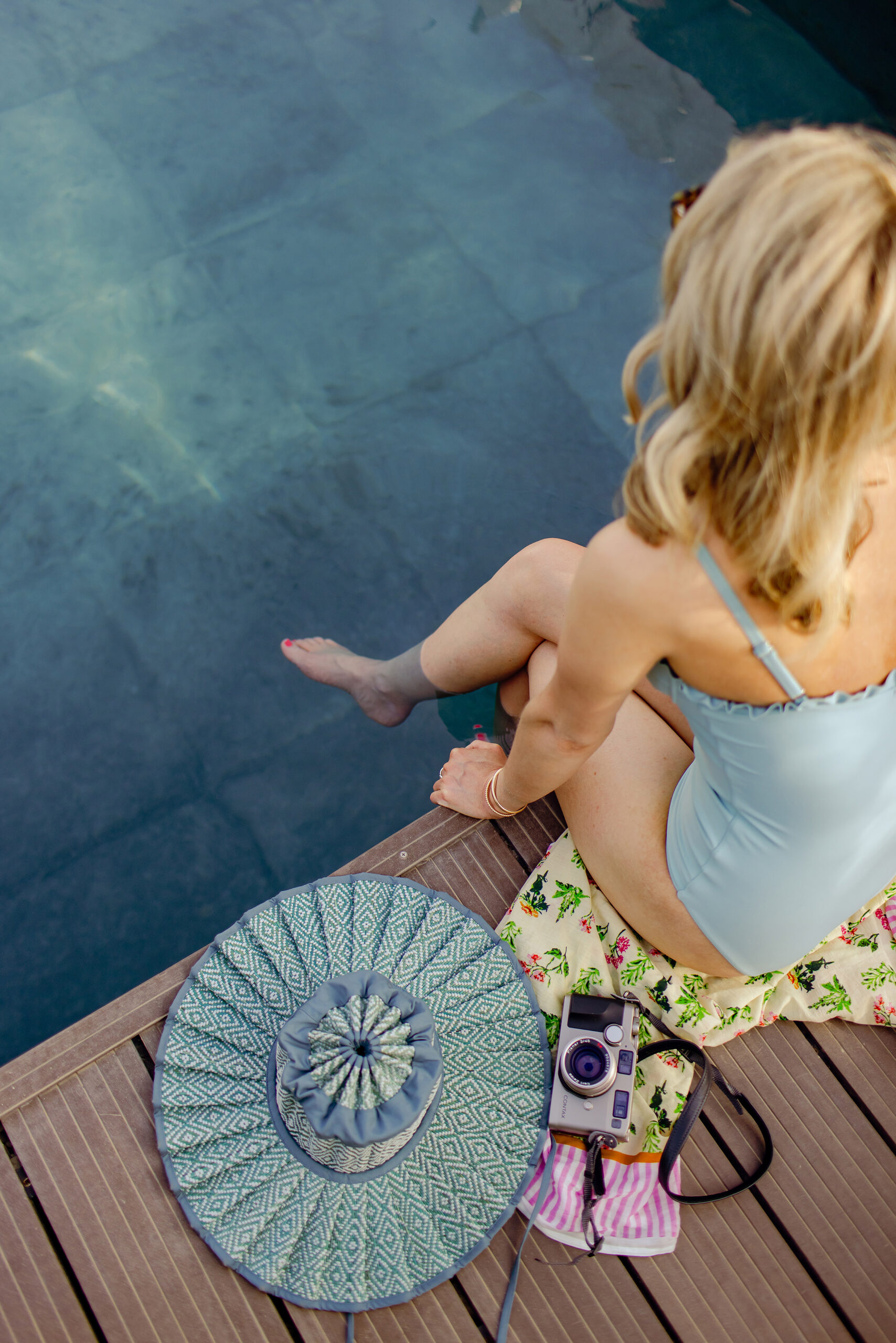 Represents a creative business owner working remotely with a relaxing, summery backdrop, symbolizing website design advice that helps your site work for you even when you're out of office.